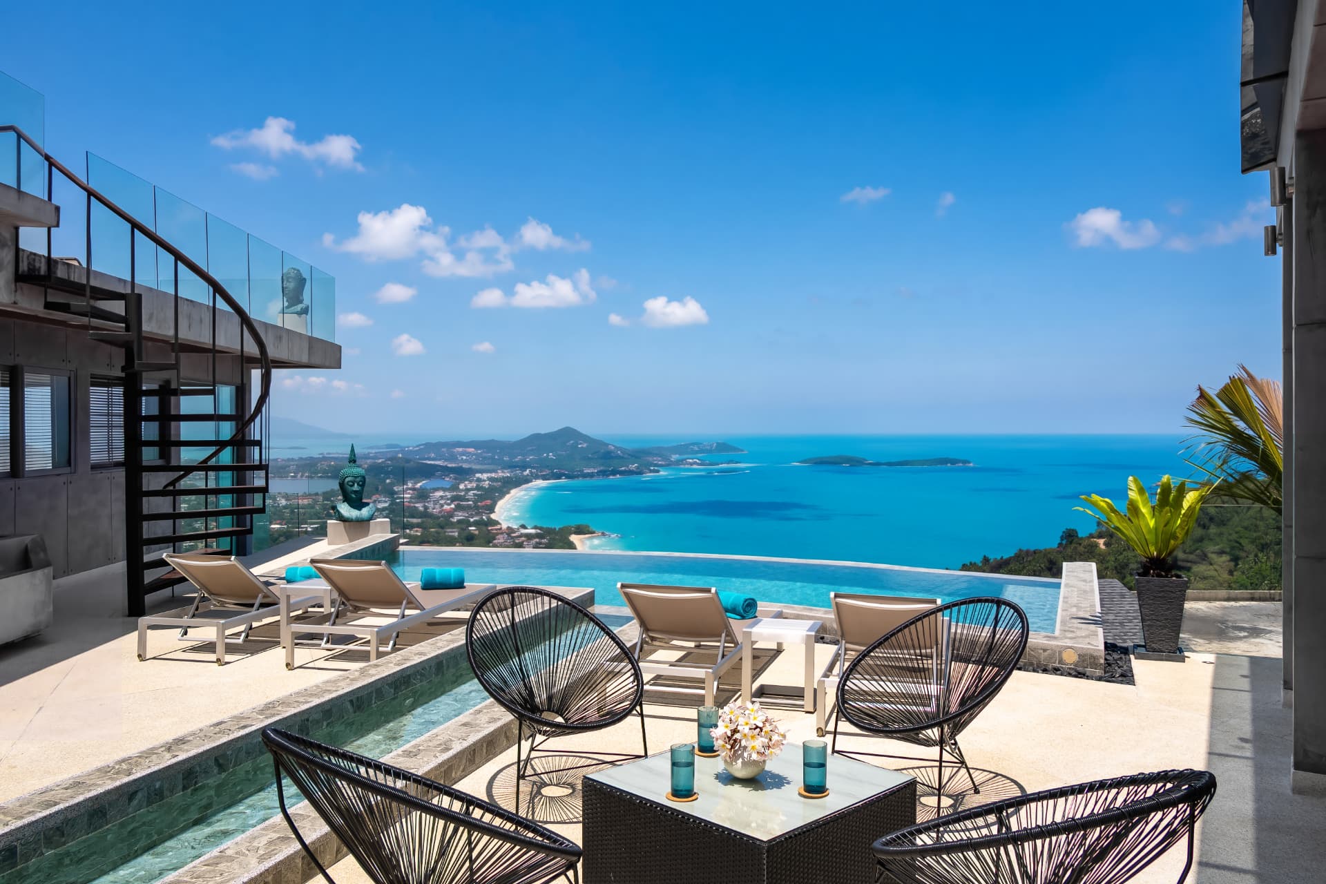 Infinity pool terrace with panoramic sea view and spiral staircase